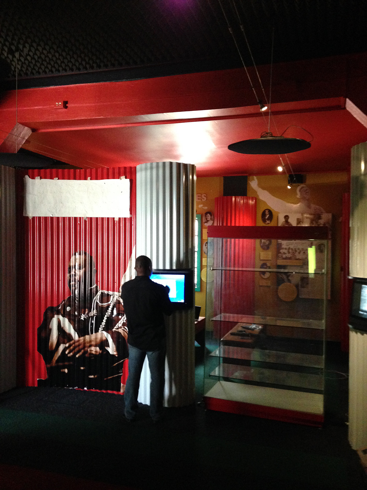 A patron interacting with a Kiosk design at the Marcus Garvey Museum in Jamacia